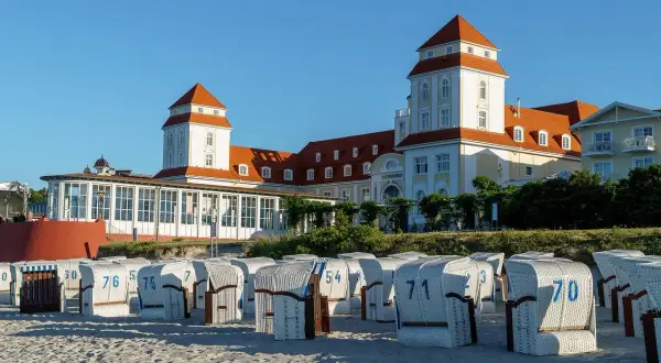 Piękne plażowe kosze czekają na turystów. W tle imponujący budynek, który stanowi jedną z głównych dźwirzyno atrakcji.